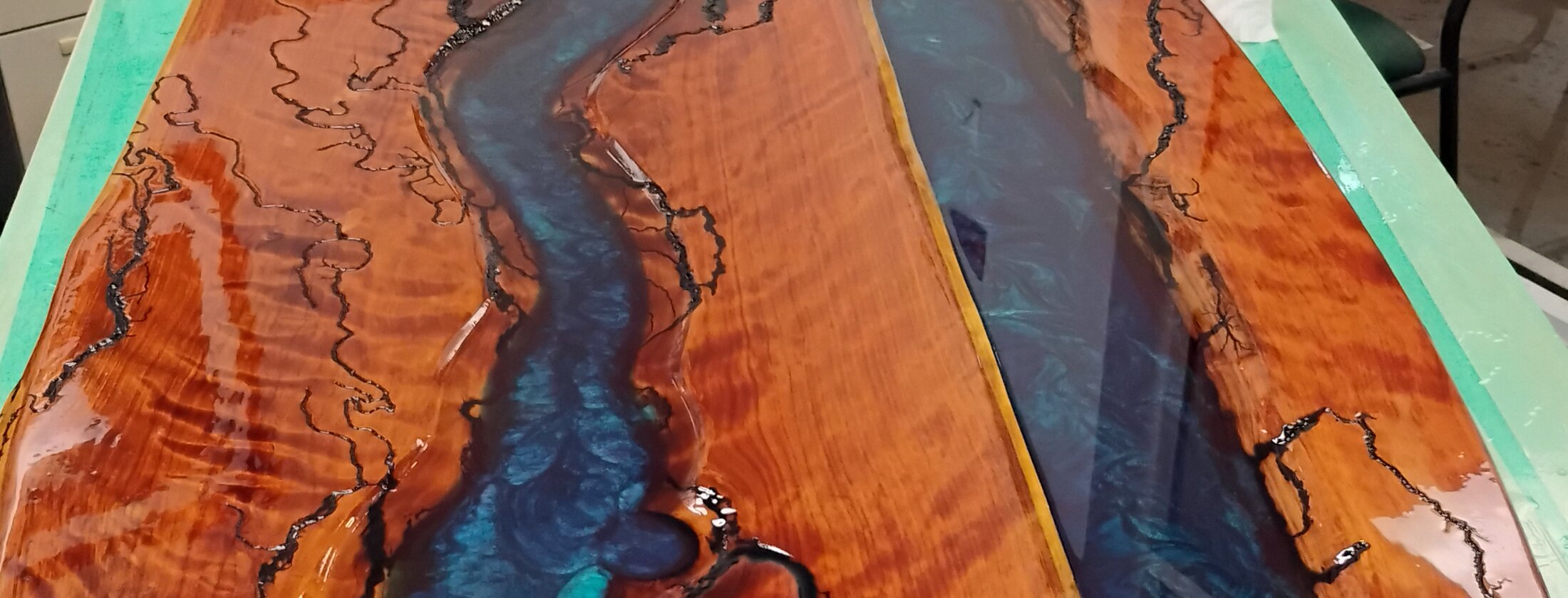Figured cherry river table with teal and cobalt resin
