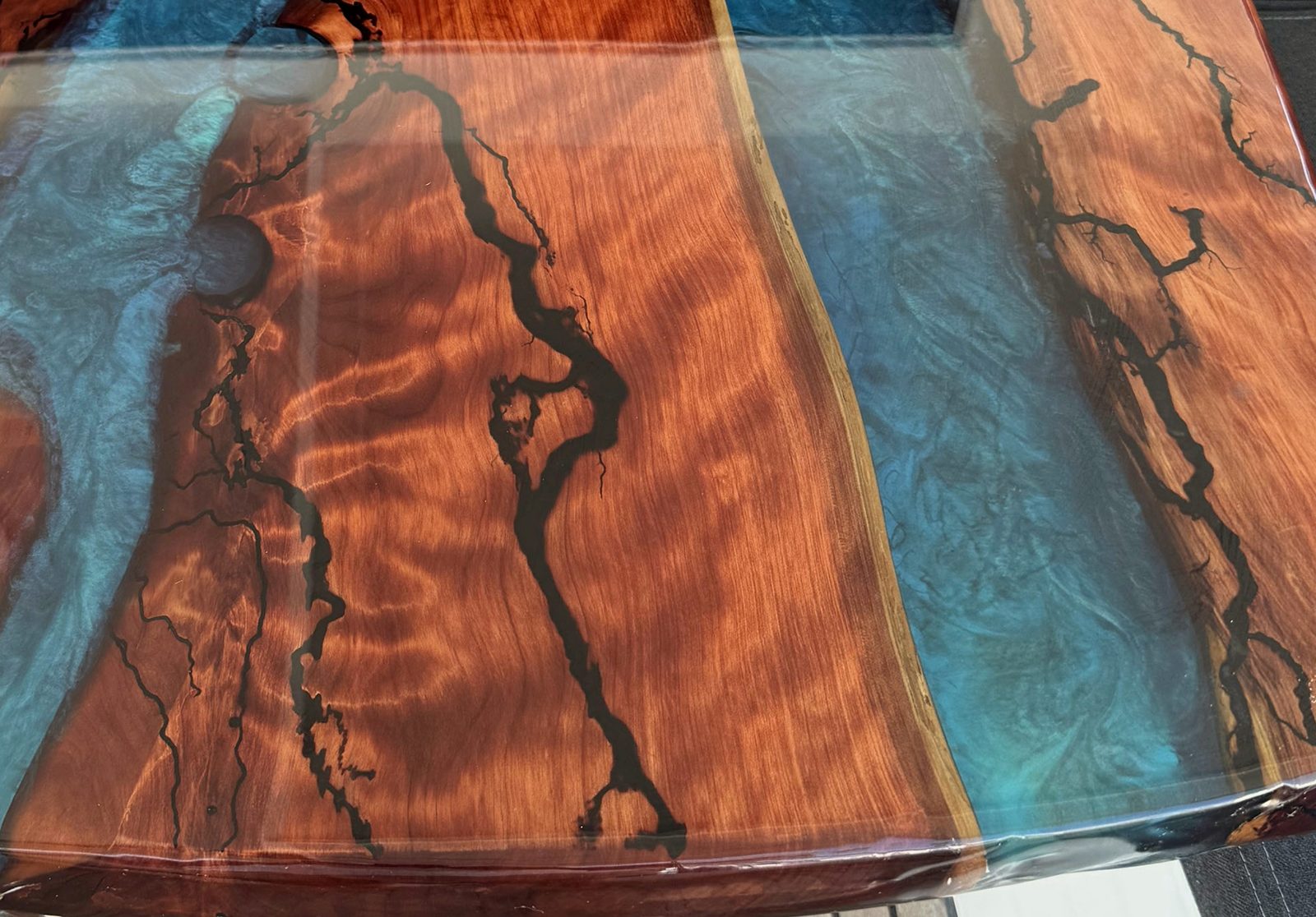 Edge of the river where resin meets live edge