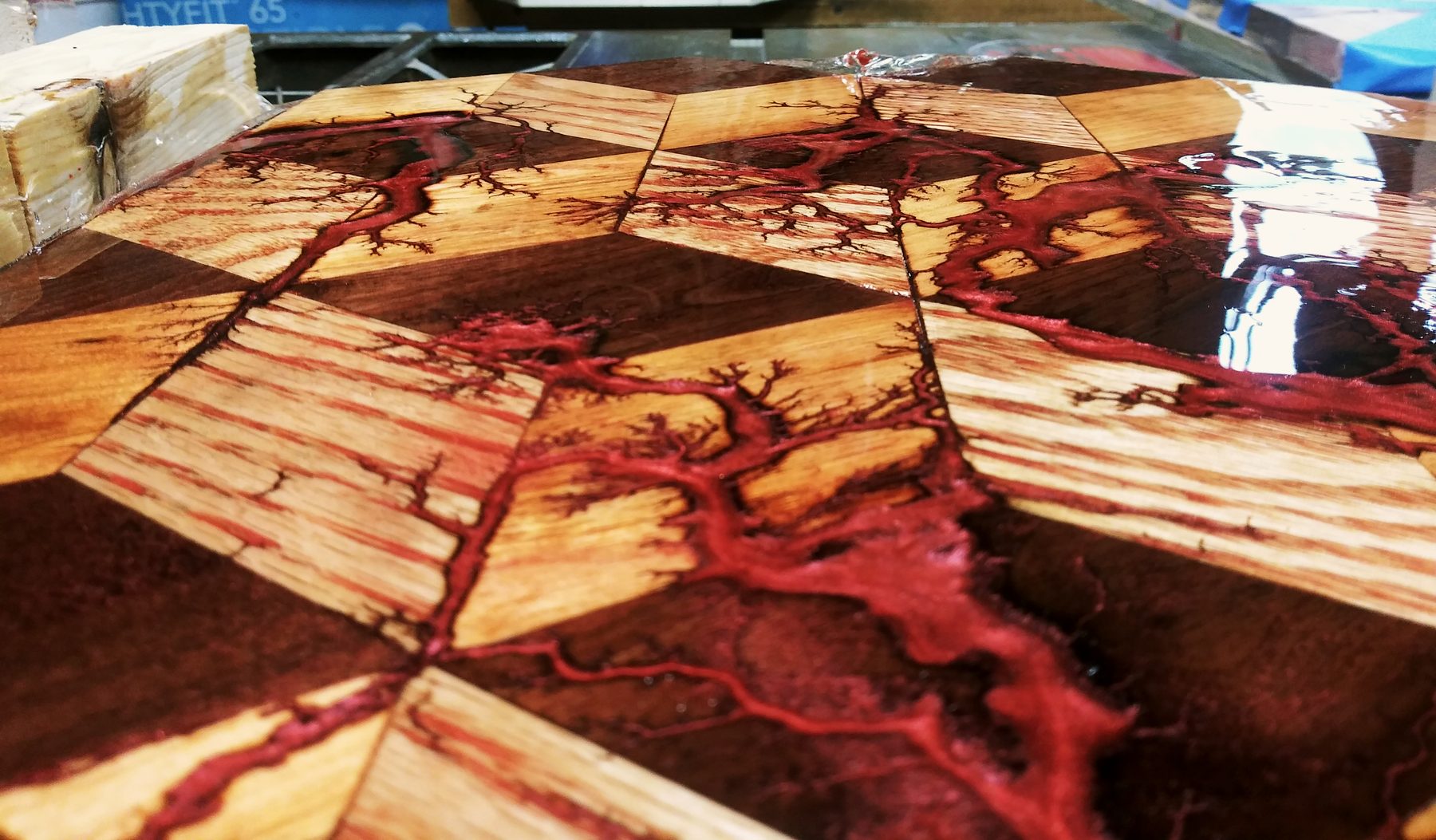 Red resin running through Lichtenberg burns